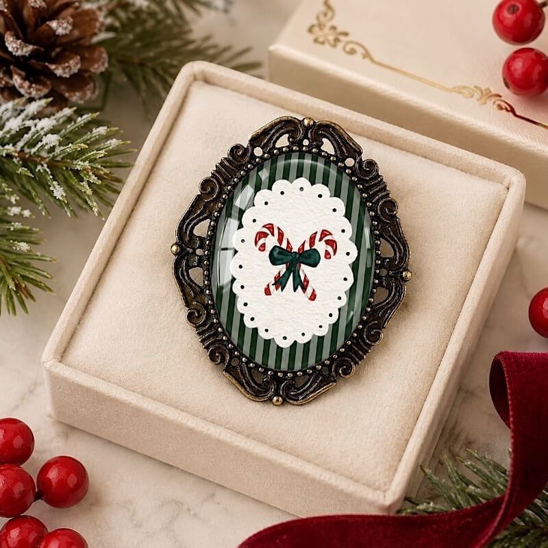Holiday brooch with candy cane design, green stripes, and ornate frame, perfect for festive occasions