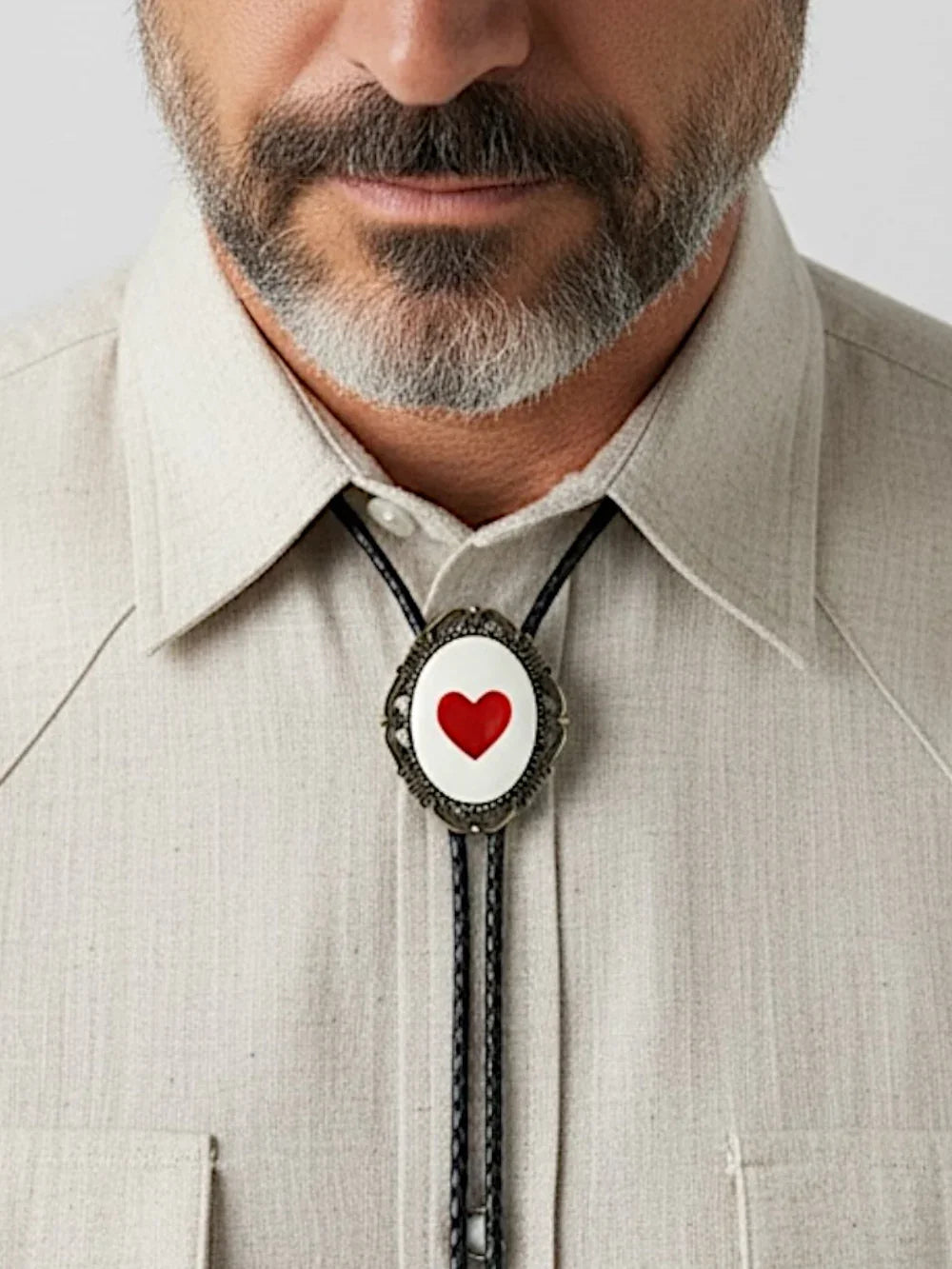 Heart bolo tie on a man with and beard.