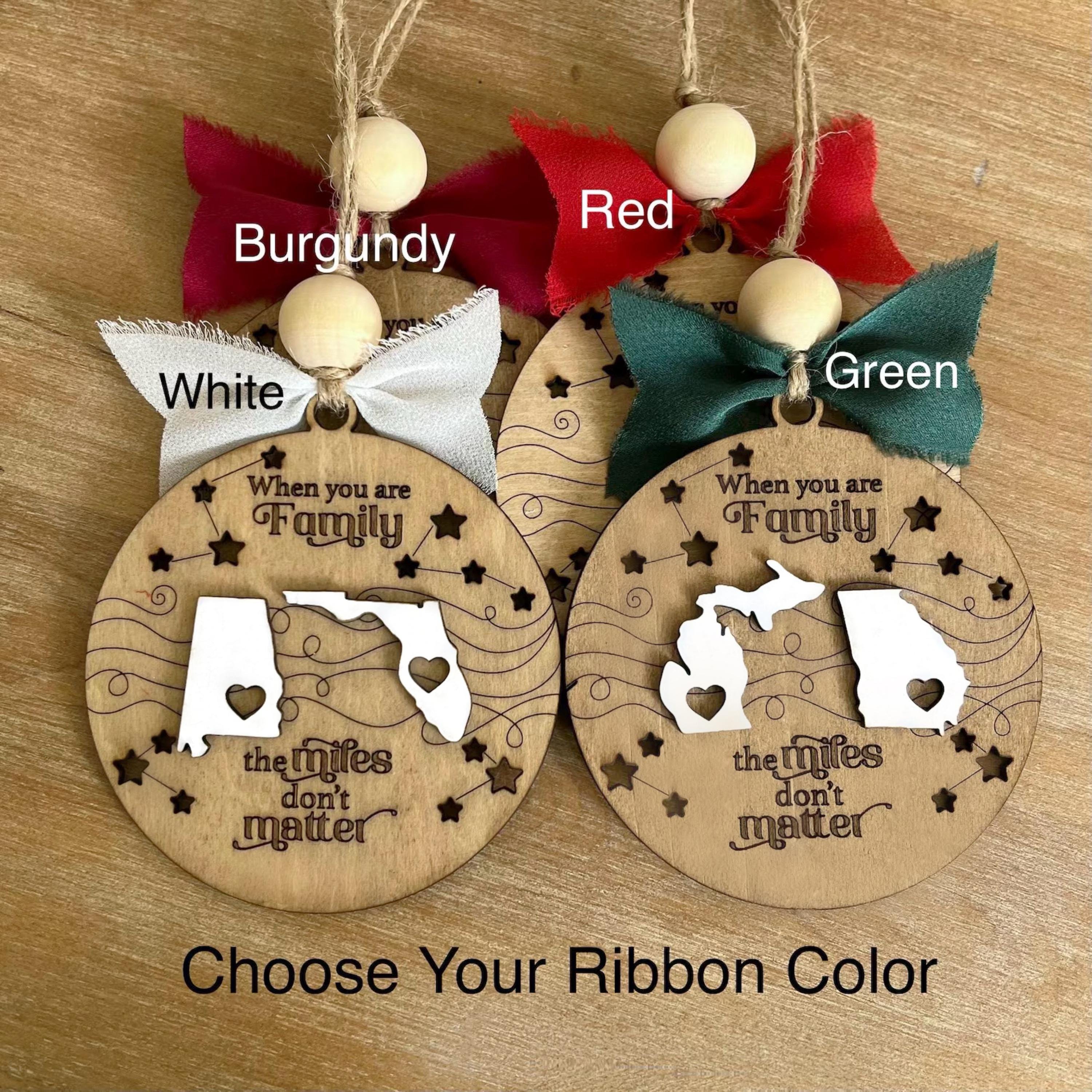 three wooden ornaments with the names of three states