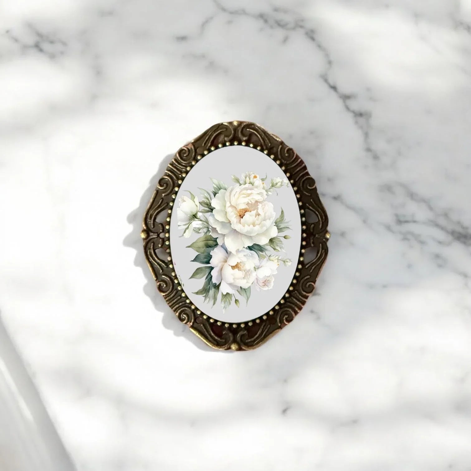 Handmade brass brooch for her showcasing intricate botanical engraving and traditional artisan craftsmanship.