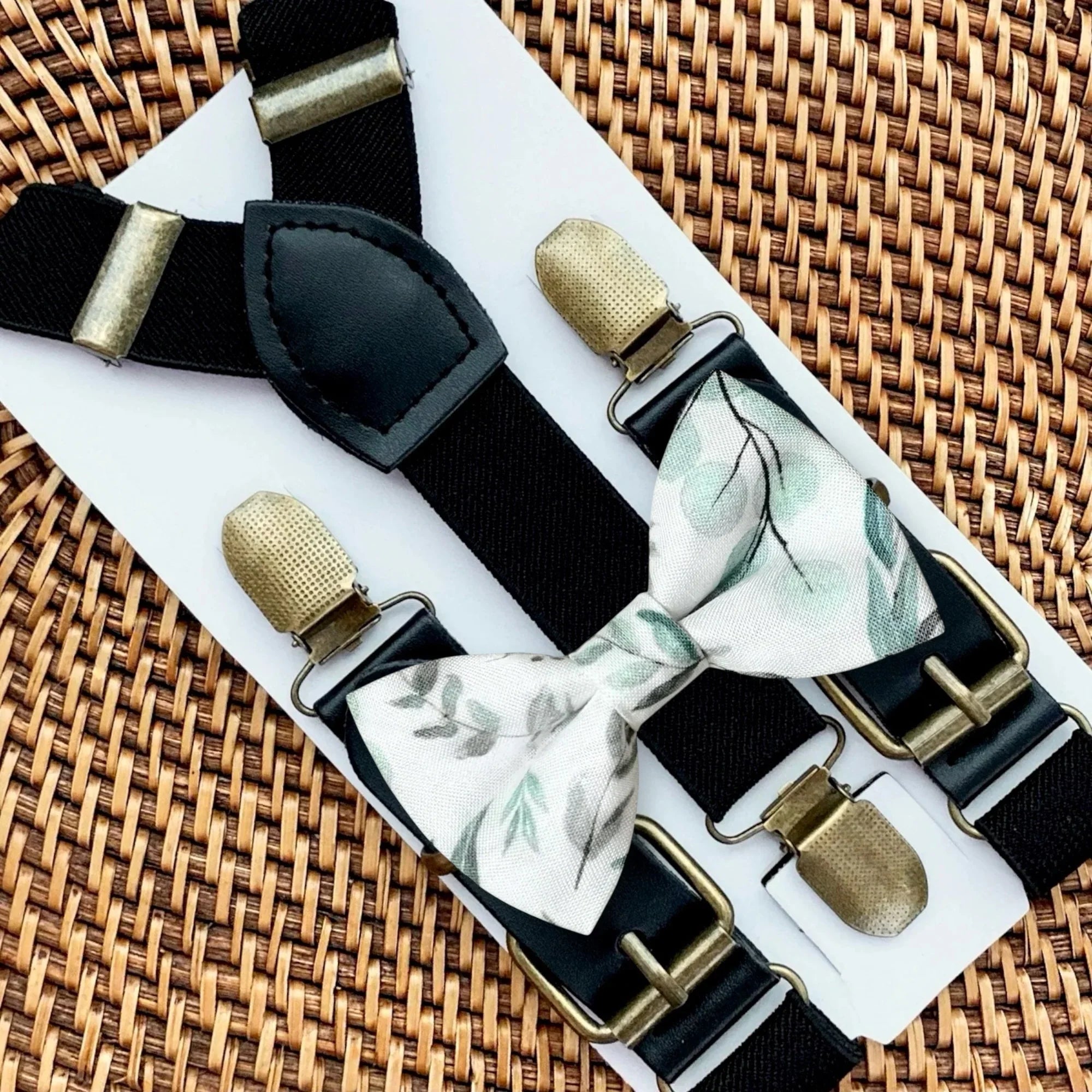 Sage green floral bow tie and black suspenders.