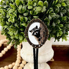 Western Bolo Tie with Raccoon with black leather cord decorative green boxwood arrangement.