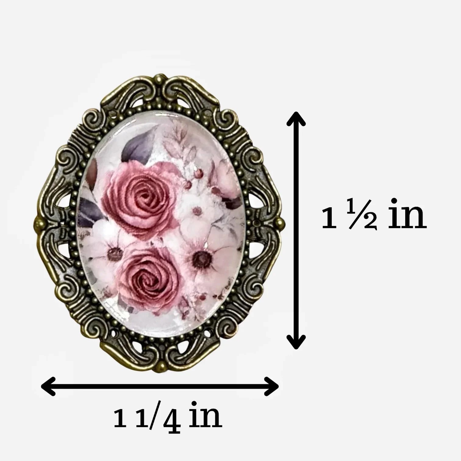 Decorative floral brooch for with measurements on a white background showing the brooch is 1 1/2 inches by 1 1/4 inches.
