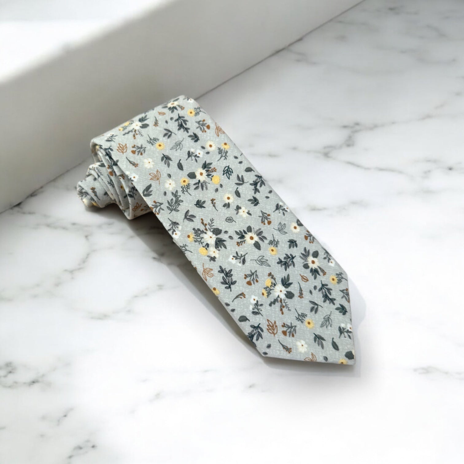 Light blue and white floral men’s tie for wedding.