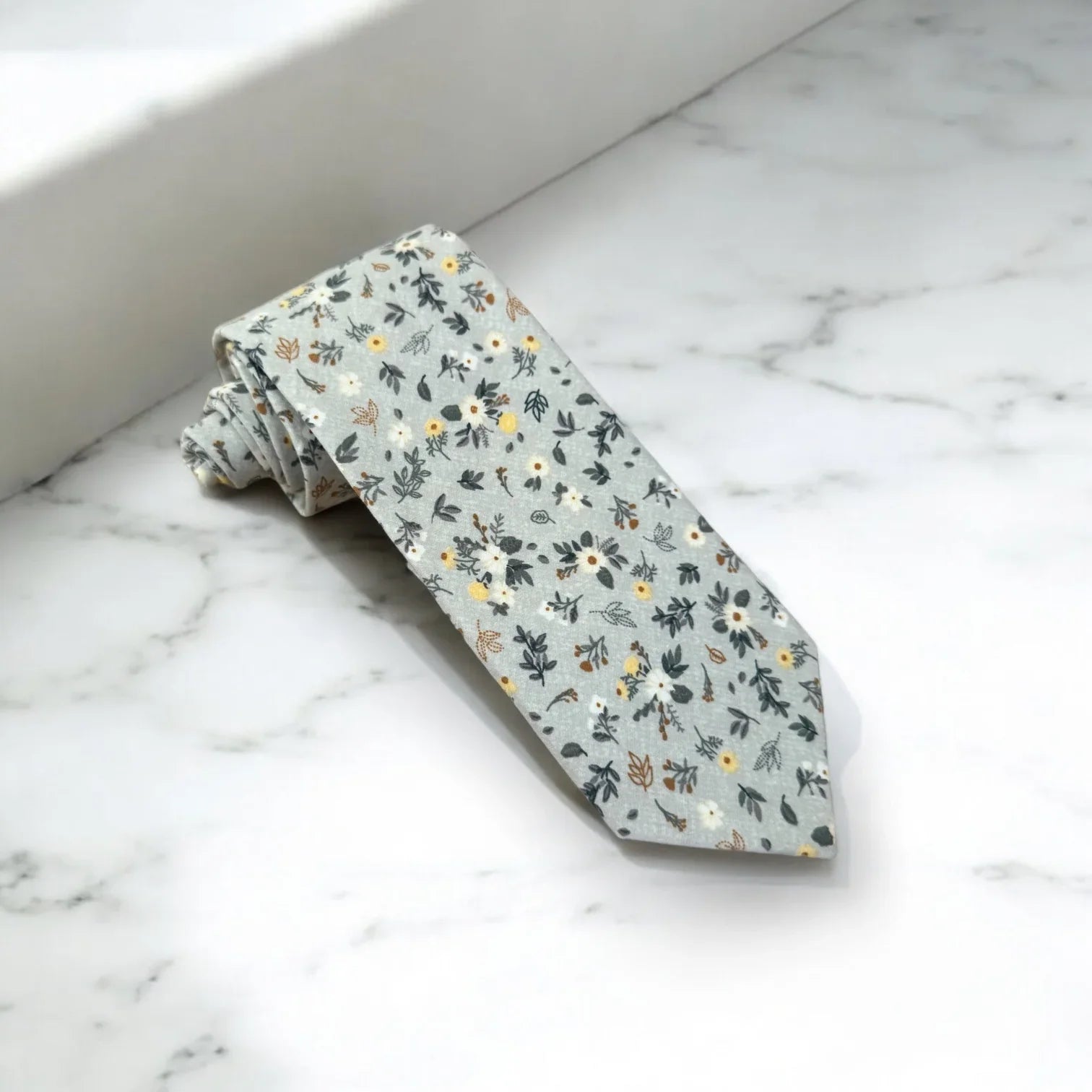 Light blue and white floral men’s tie for wedding.