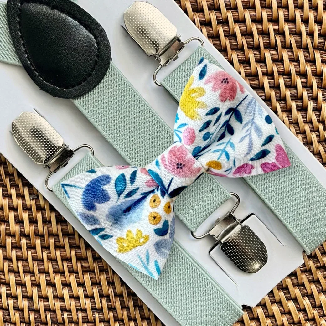 Spring floral bow tie with multicolor flowers paired with sage suspenders on a white display card