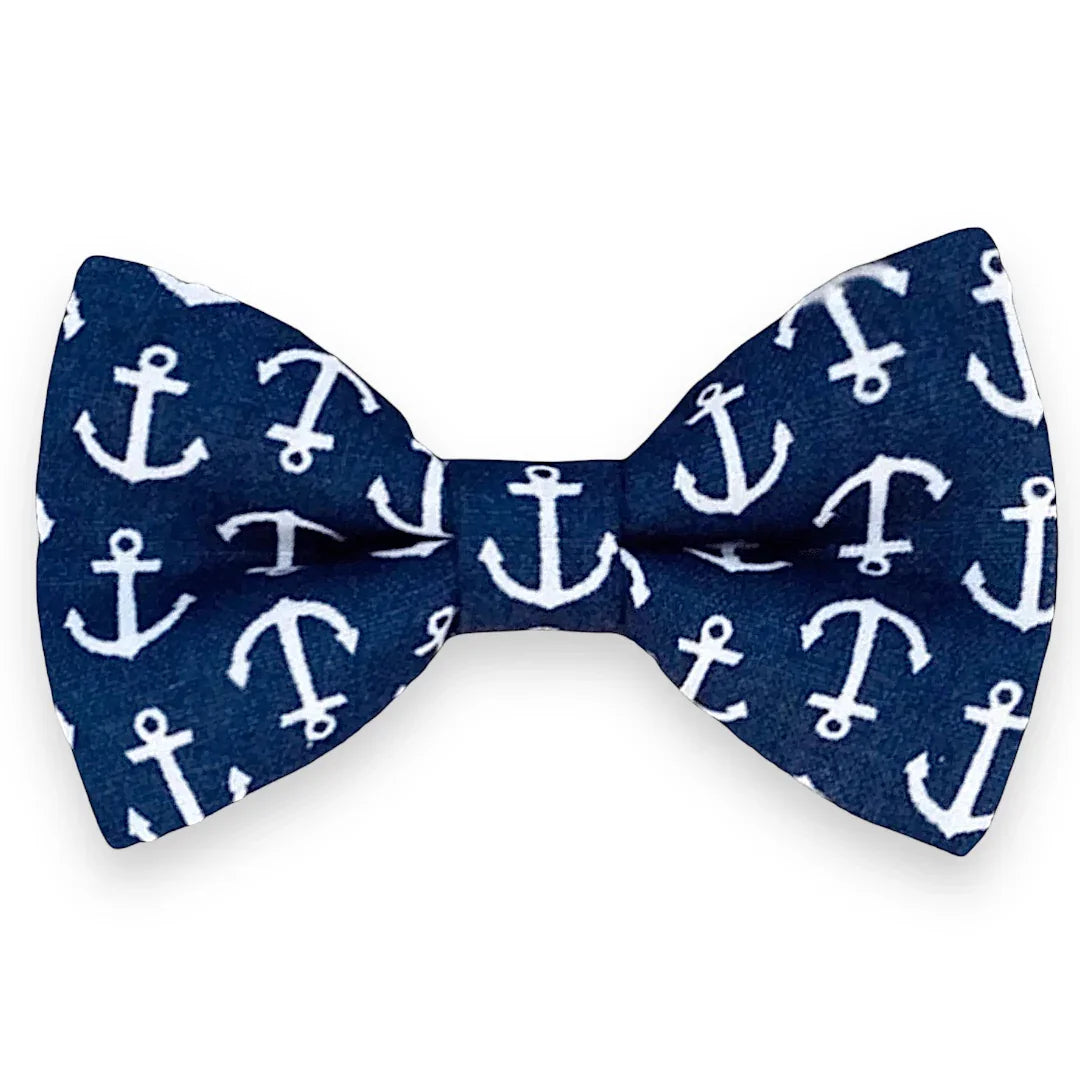 Navy blue bow tie with white anchor pattern on a white background