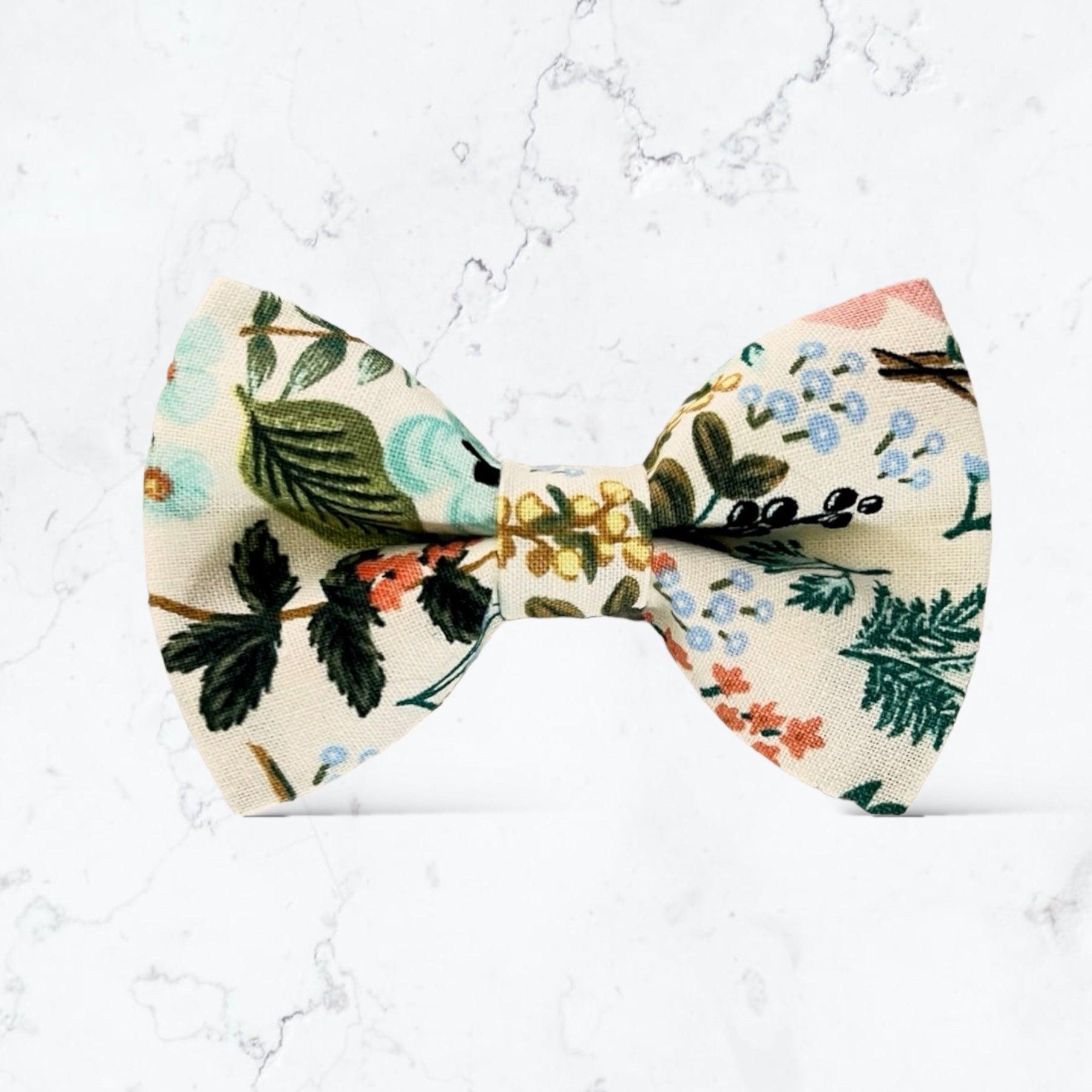 Ivory Floral Bow Tie- Made with Rifle Paper Co fabric, Mens Wedding Bowtie for groomsmen, ring bearers and groom against a marble background.
