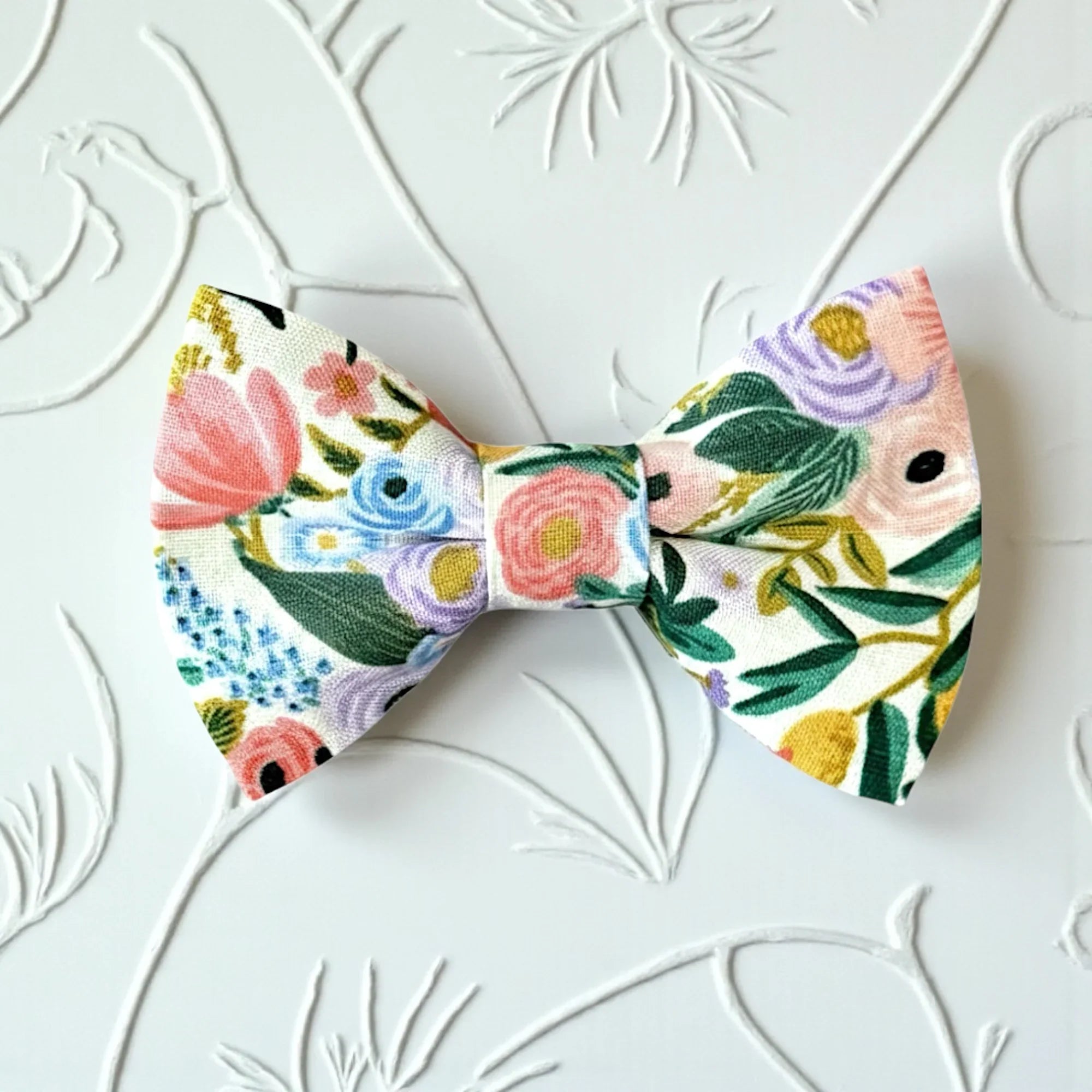 Floral patterned bow tie on a textured white background