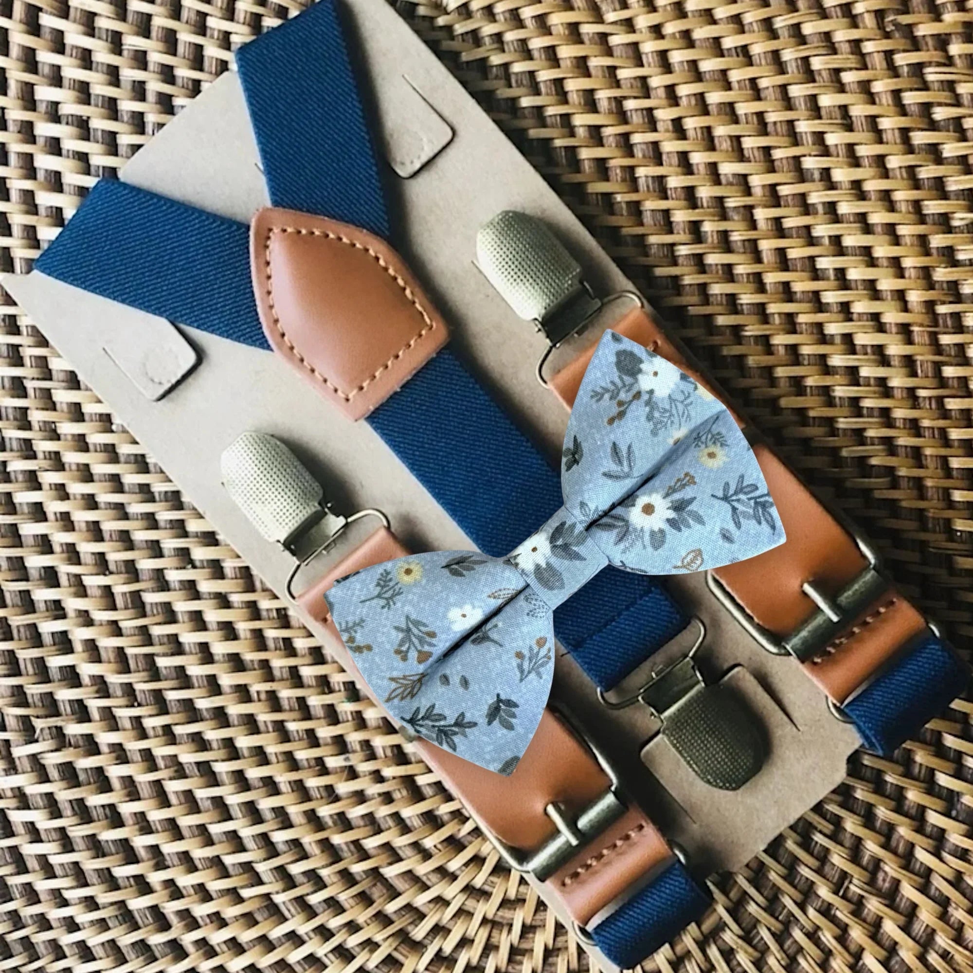 Light blue floral bow tie and navy blue suspenders for weddings.