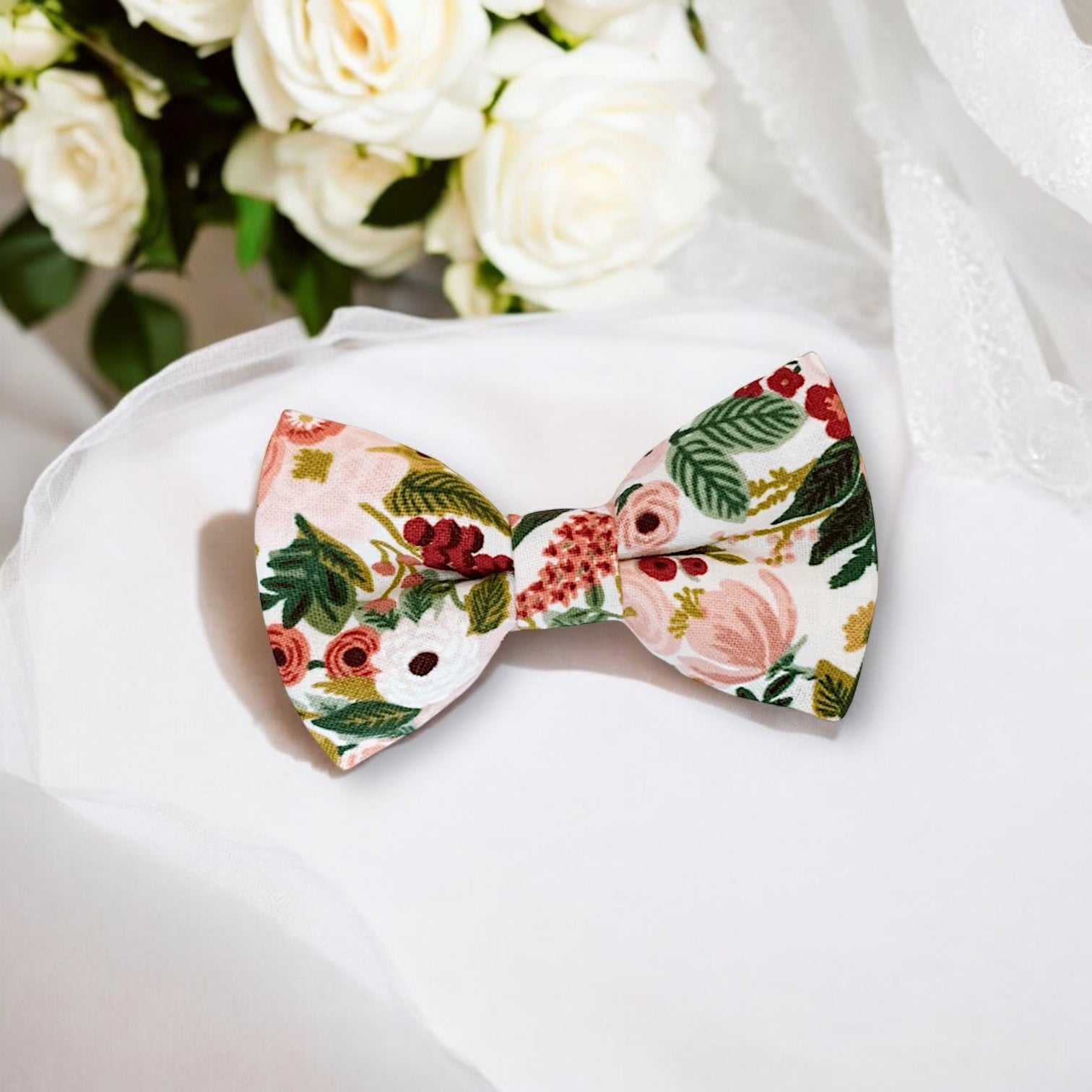 Maroon burgundy floral Bow Tie in for weddings, groomsmen and ring bearers surrounded outfits in rifle paper co fabric surrounded by wedding accessories.