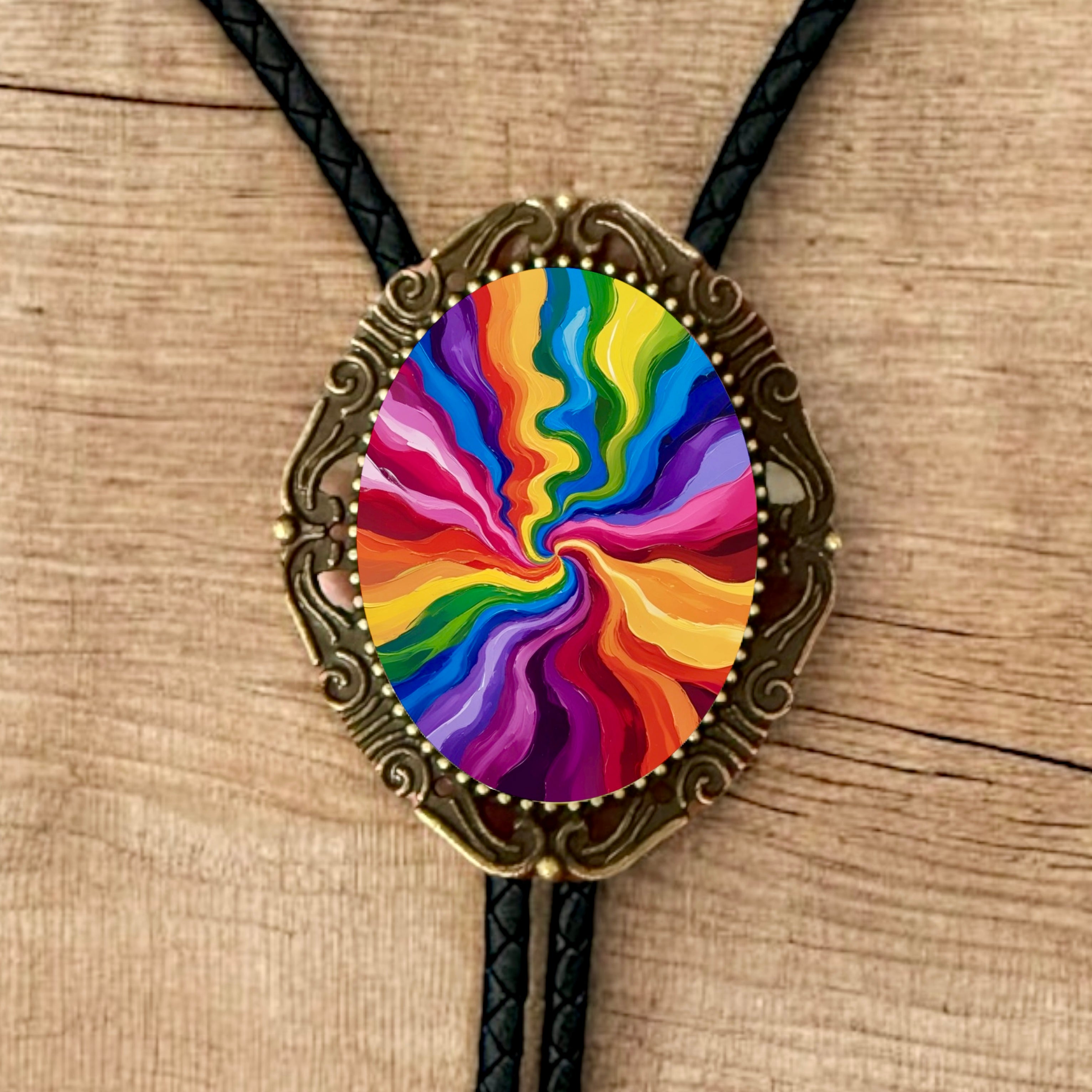 Colorful spiral design bolo tie on a wooden surface