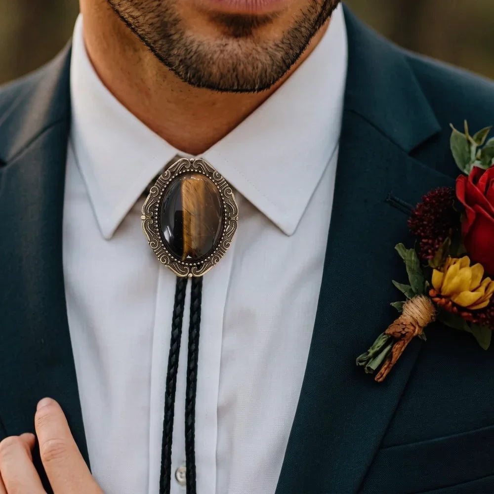 Bolo Tie for men with Tigers Eye Stone worn by a groomsman with a navy suit standing by a woman.