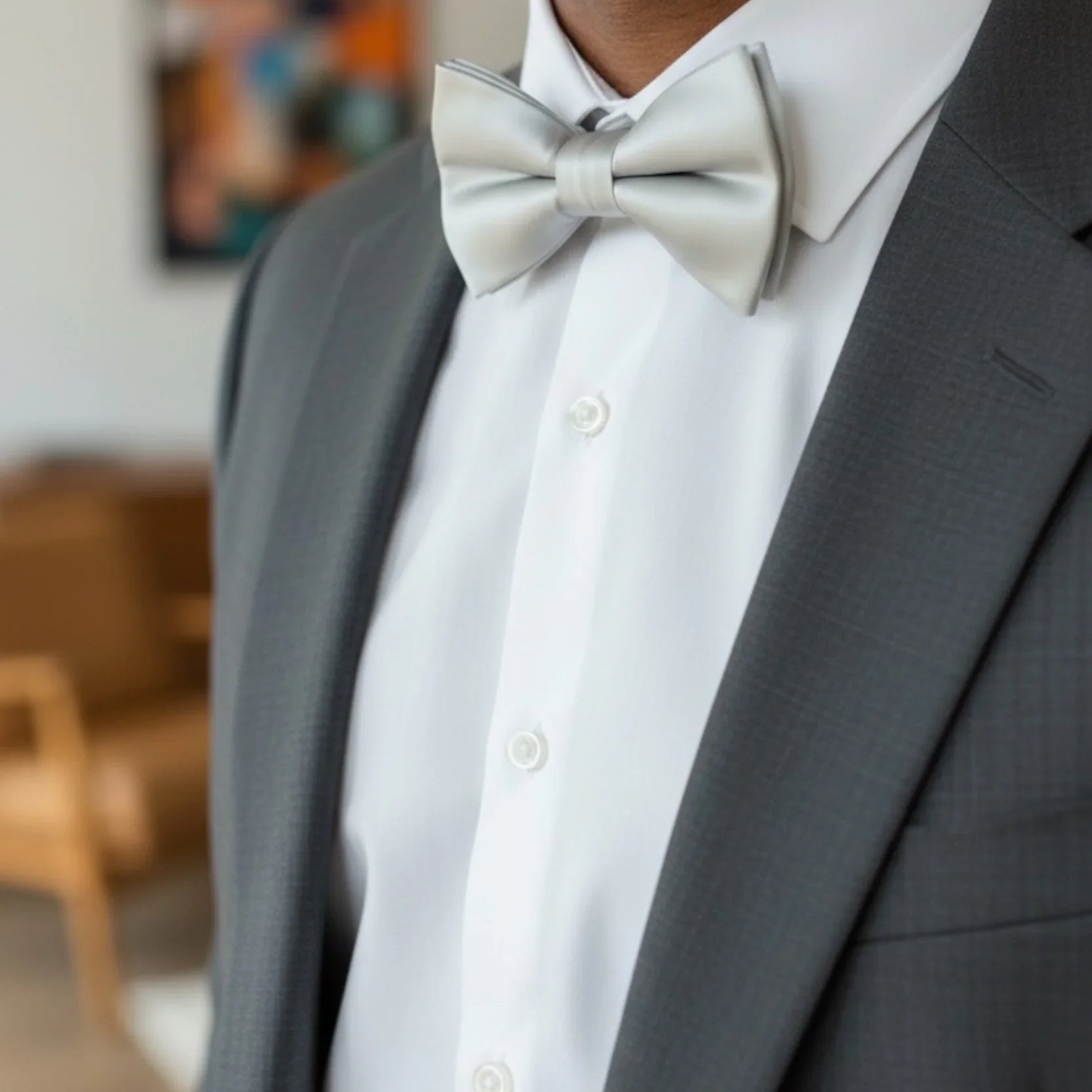 Size chart for pre-tied bow ties from The Bold Bow Tie detailing measurements across three sizes. Small is 3.5 inches wide and recommended for ages 6 months to 5 years. Medium is 4 inches wide and recommended for ages 6 to 12 years. Large is 4.5 inches wide and recommended for ages 13 years and up. Visual icons illustrate the relative sizes with horizontal arrows showing that width is measured from wingtip to wingtip. Bottom text notes that all bow ties are pre-tied and ready to add to your outfit.
