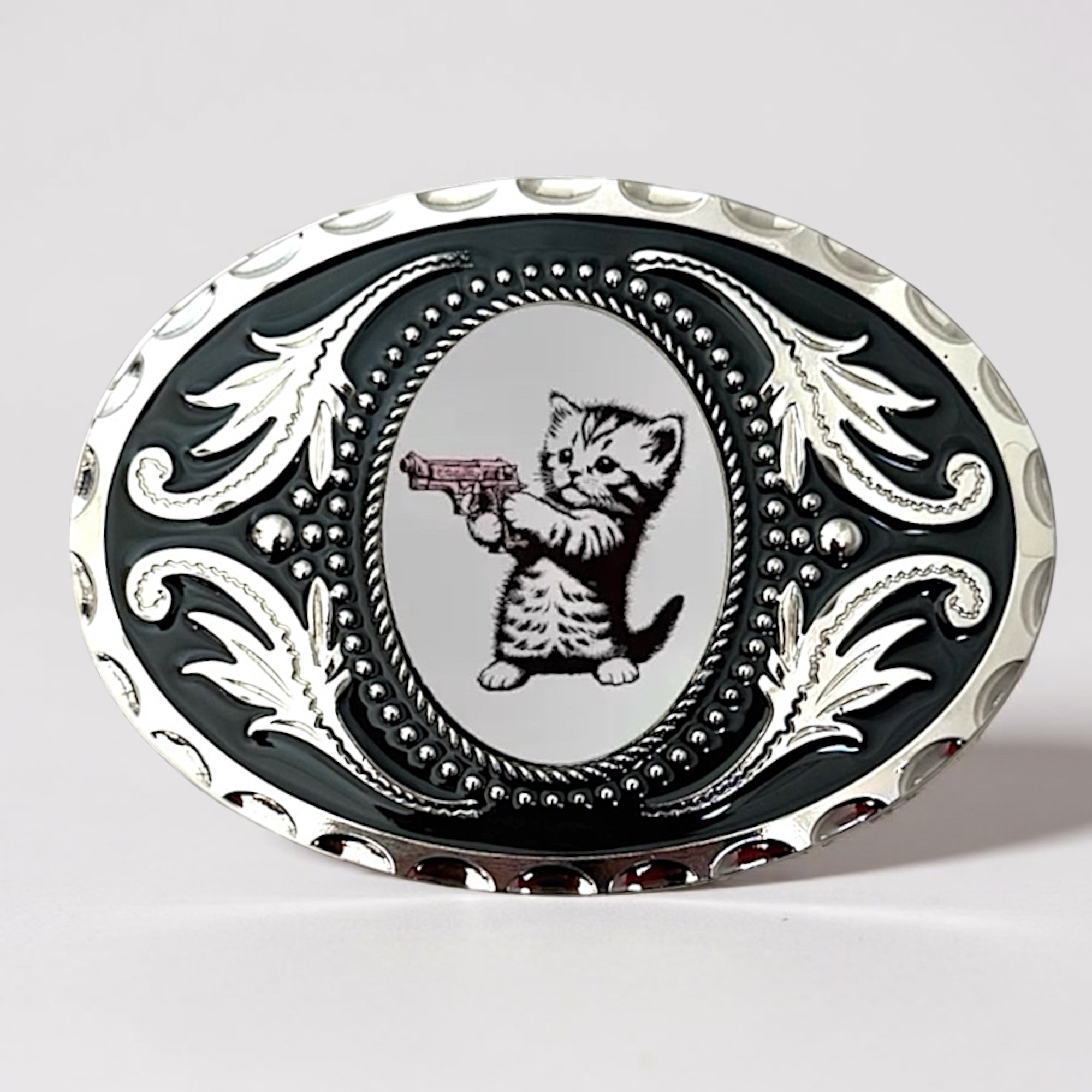 Cat Belt buckle with a design of a kitten holding a gun on a white background
