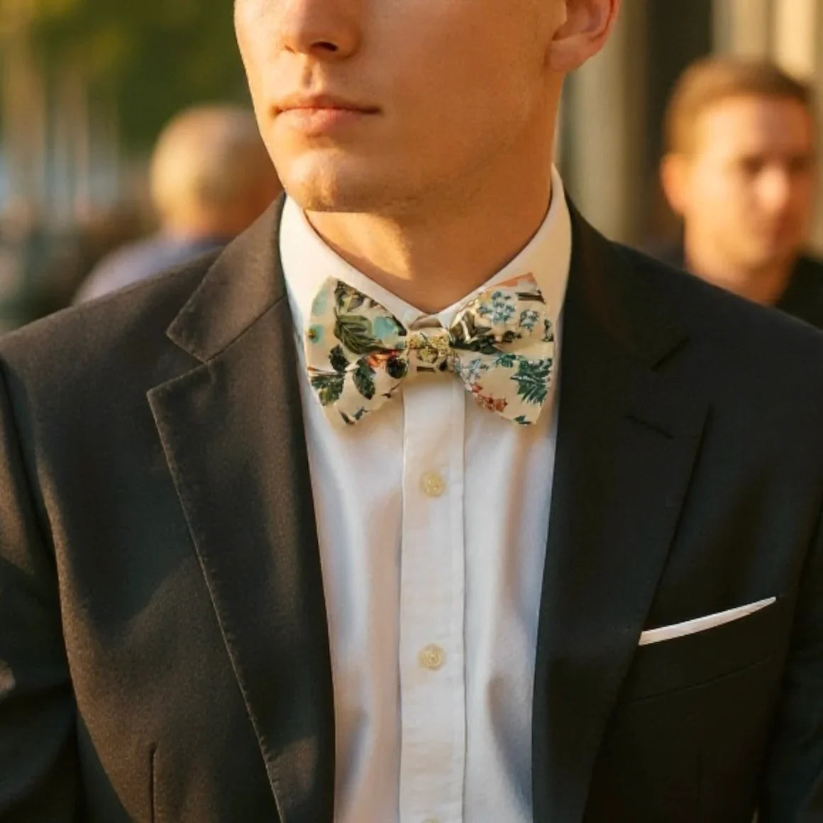 Floral bow tie for men worn by a groomsman at a wedding.