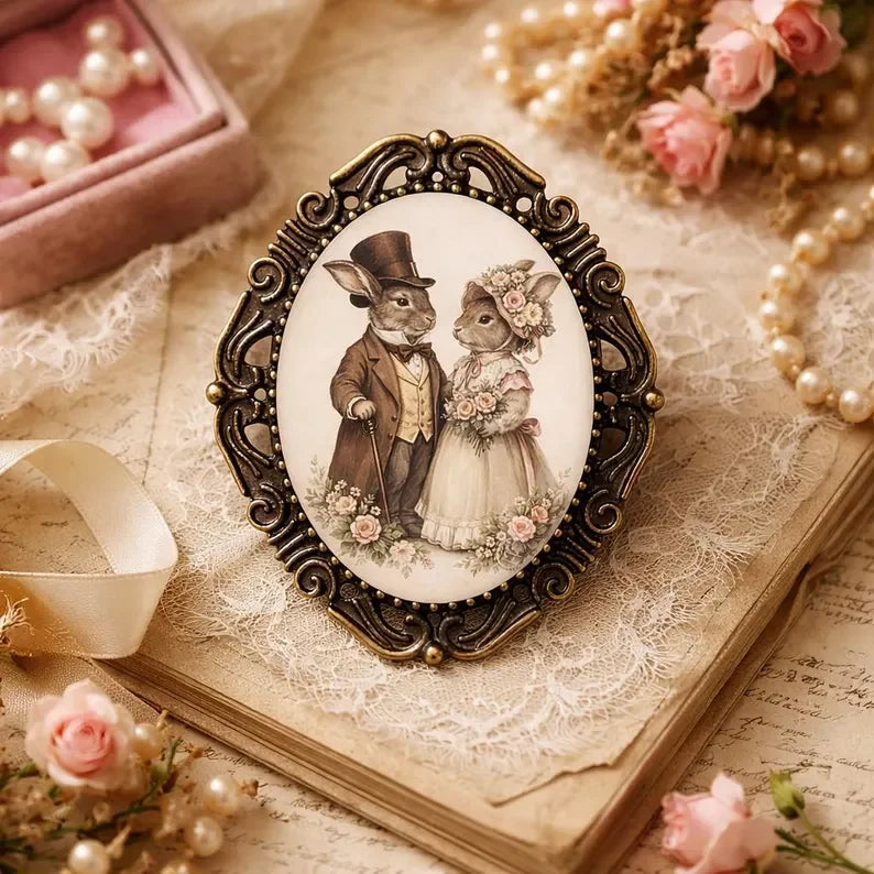 Easter Decorative brooch with rabbit couple design on an old book with pearls and flowers.