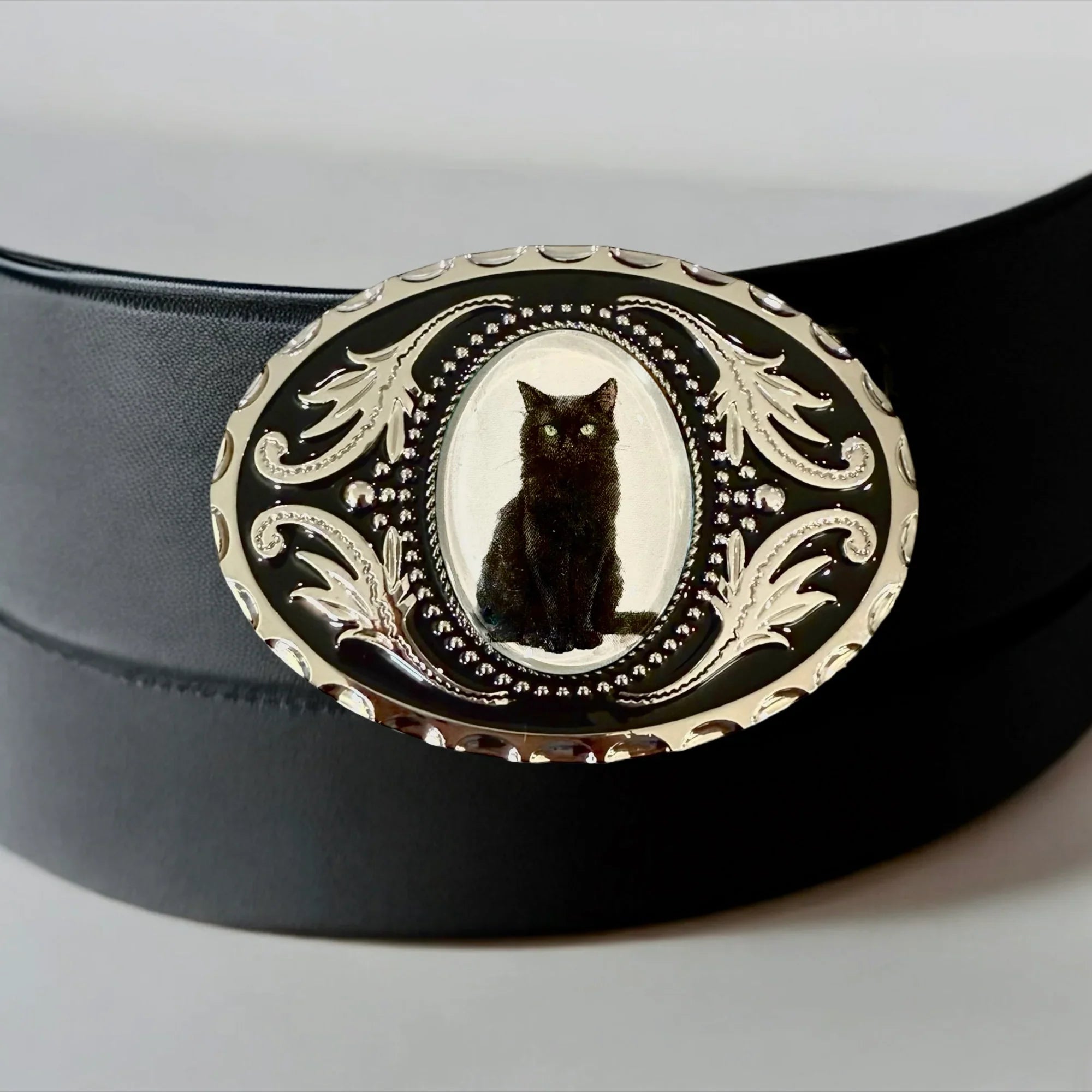 Two options for belt buckles: Option 1 has a leaf pattern and option 2 has flowers on it