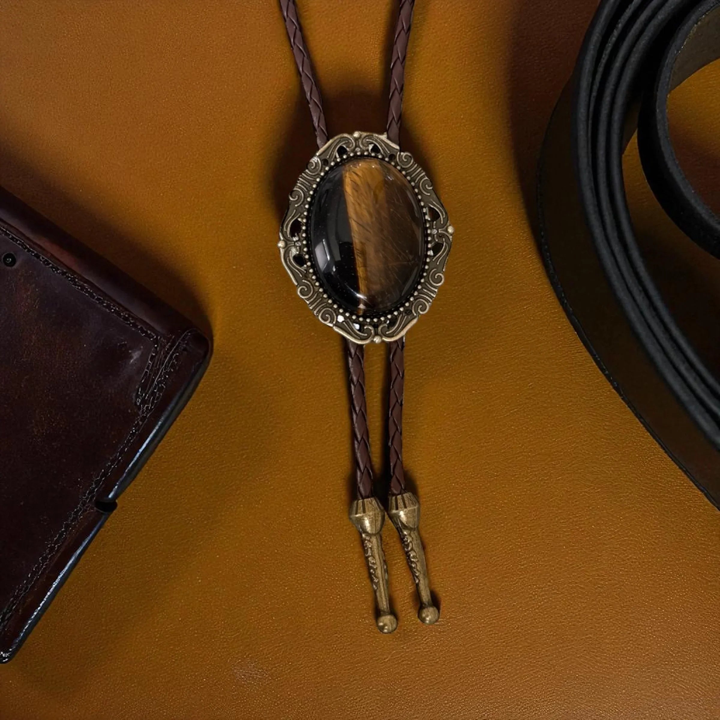 Bolo tie with tiger's eye stone on a brown background