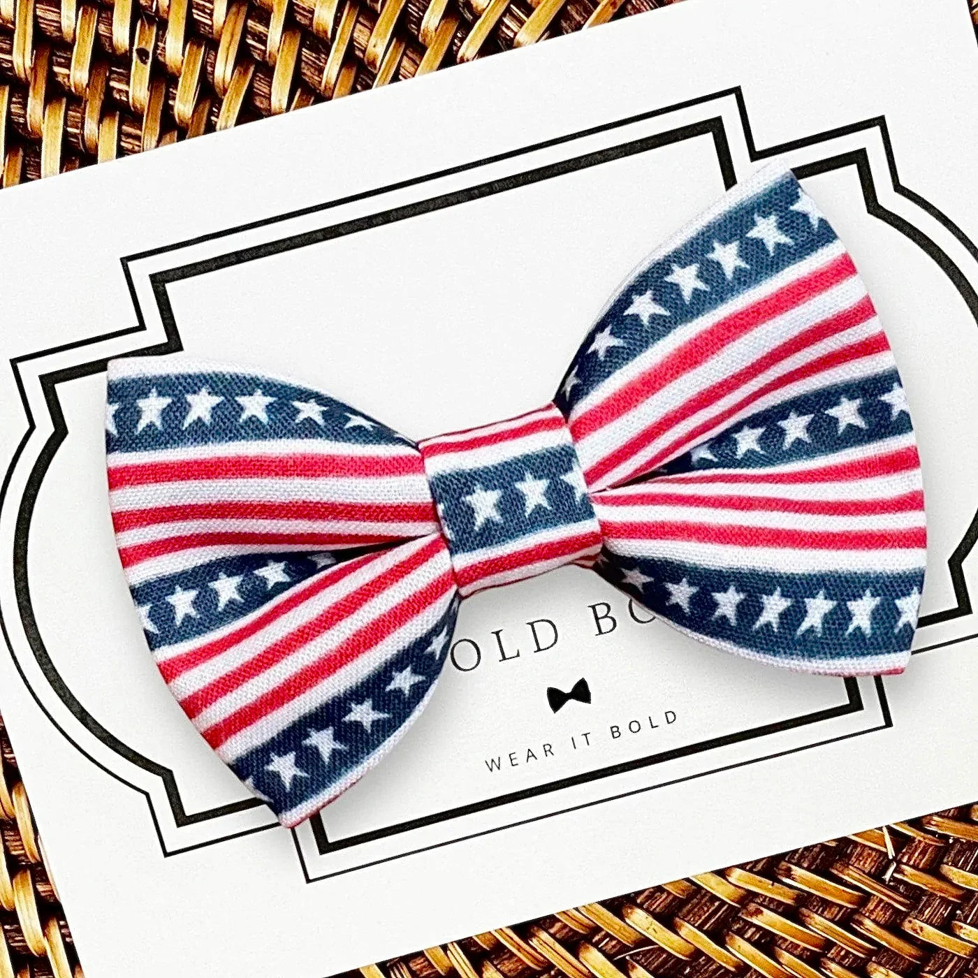 Patriotic red white and blue bow tie with stars and stripes on a white card background