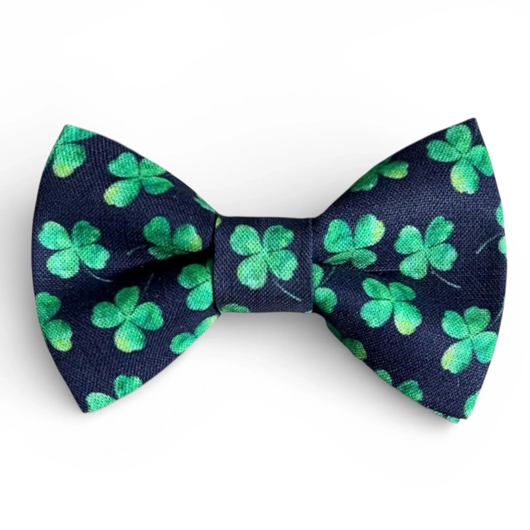 Navy blue bow tie with green shamrock pattern on a white background