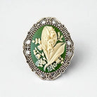 Decorative brooch with floral design on a white background