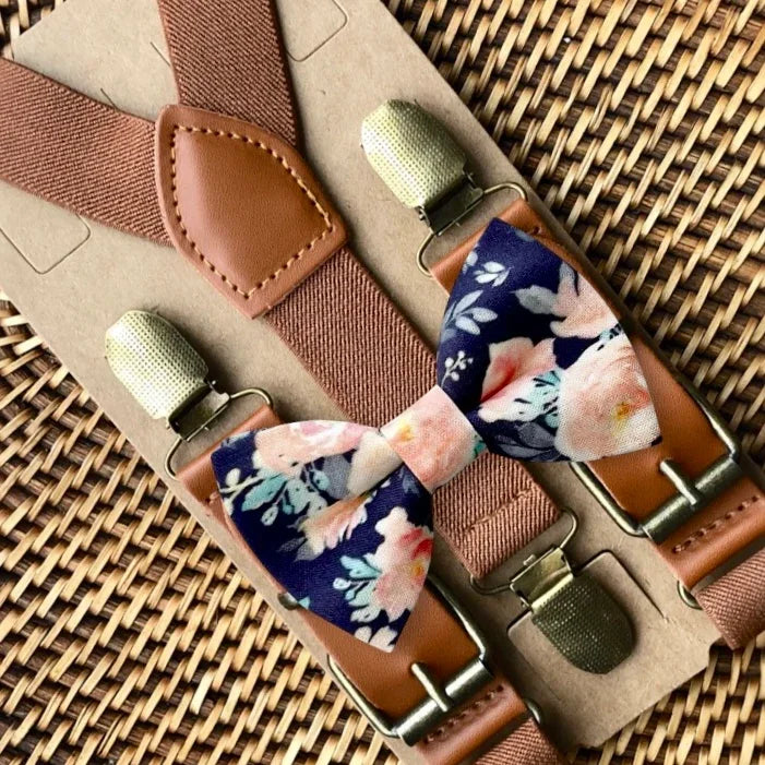 Navy floral bow tie with pink flowers paired with brown suspenders