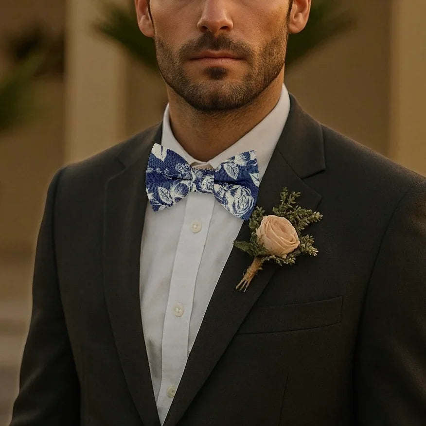 Navy floral bow tie for men worn by a man in a suit as a groomsman.
