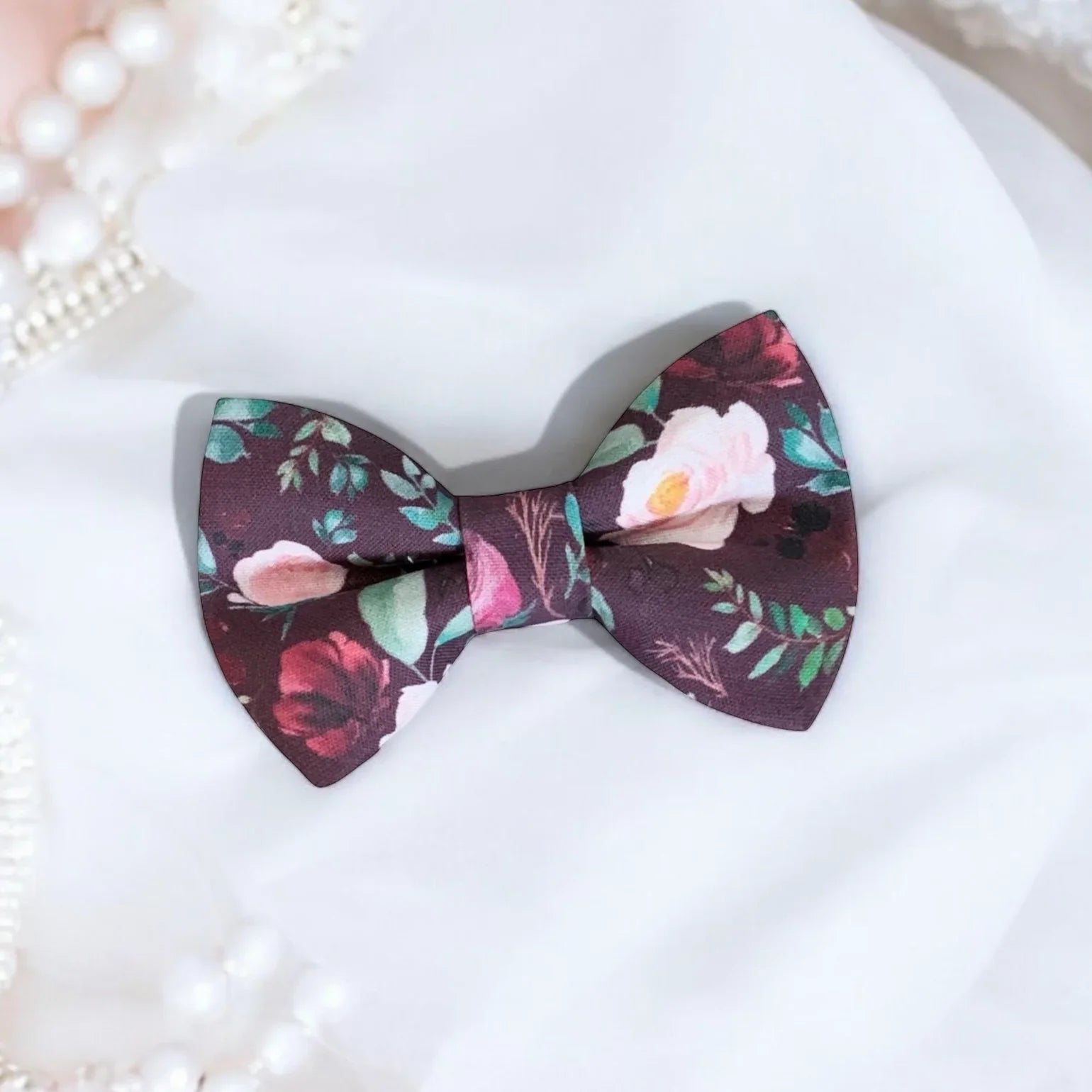 Size chart for pre-tied bow ties from The Bold Bow Tie detailing measurements across three sizes. Small is 3.5 inches wide and recommended for ages 6 months to 5 years. Medium is 4 inches wide and recommended for ages 6 to 12 years. Large is 4.5 inches wide and recommended for ages 13 years and up. Visual icons illustrate the relative sizes with horizontal arrows showing that width is measured from wingtip to wingtip. Bottom text notes that all bow ties are pre-tied and ready to add to your outfit.