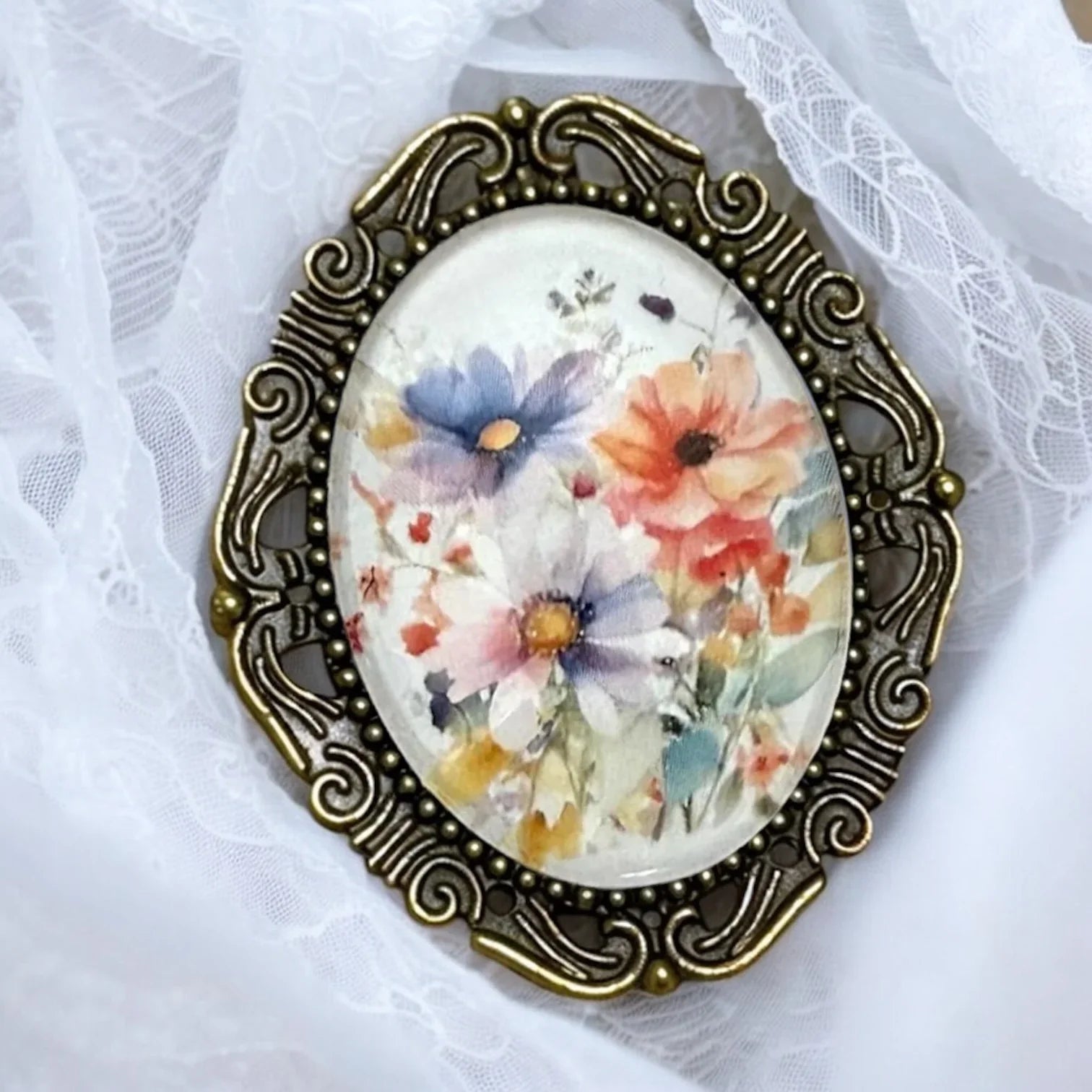 Decorative floral brooch for her with floral design on a white lace background