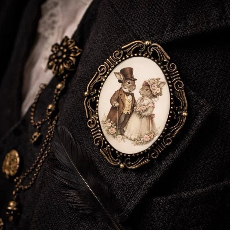 Decorative brooch with Easter bunnies with a couple design on a dark academia background