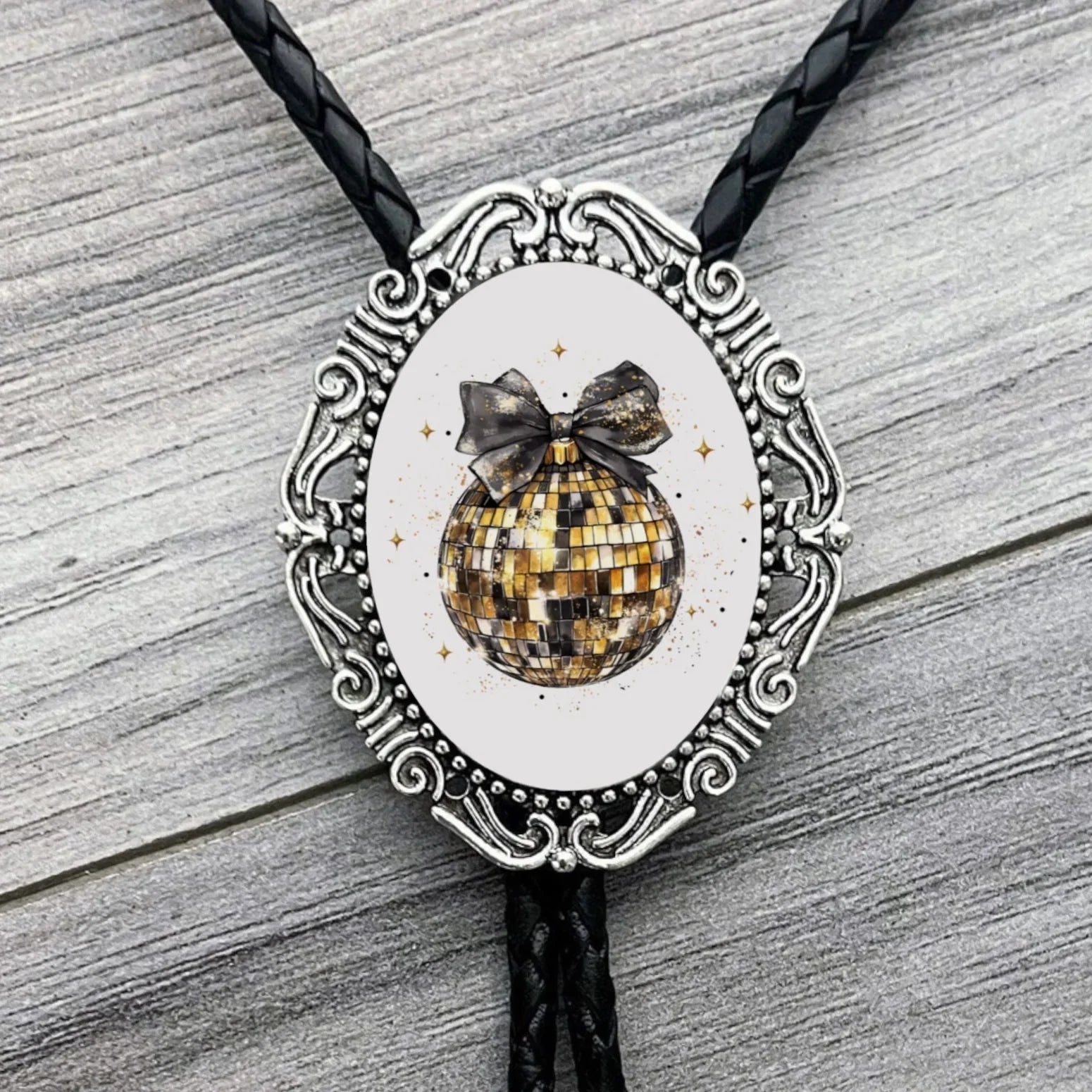 Back of a brass bolo tie with a clamp for the leather cord