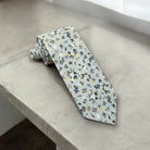 Light blue and white floral men’s tie for wedding.