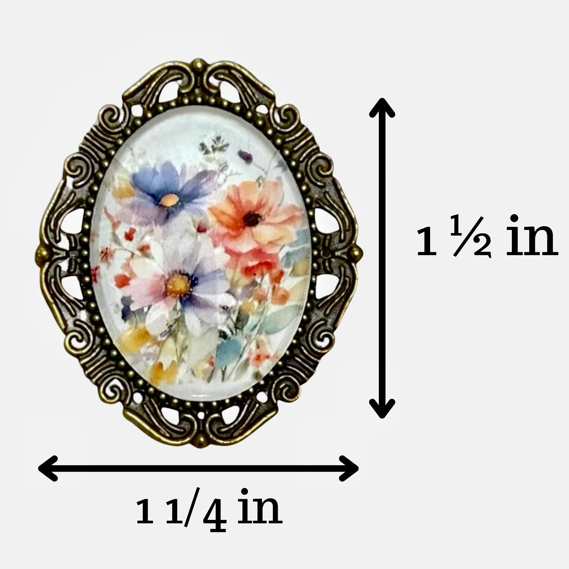 Decorative floral brooch for with measurements on a white background showing the brooch is 1 1/2 inches by 1 1/4 inches.