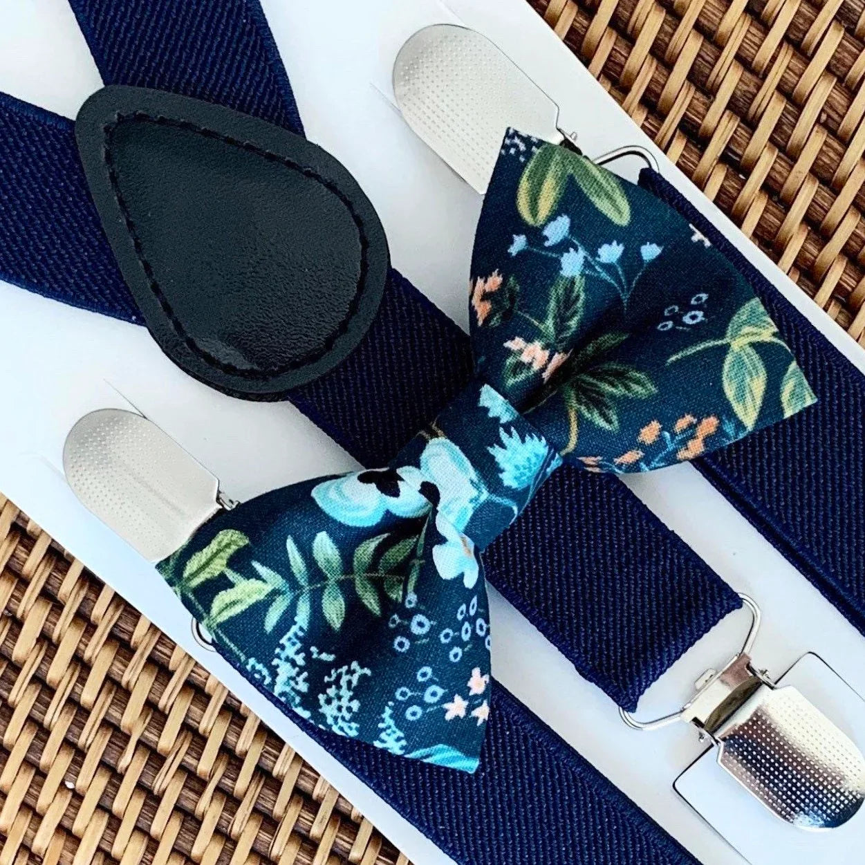 Midnight navy Rifle Paper Co bow tie with floral pattern and matching navy suspenders with metal clips