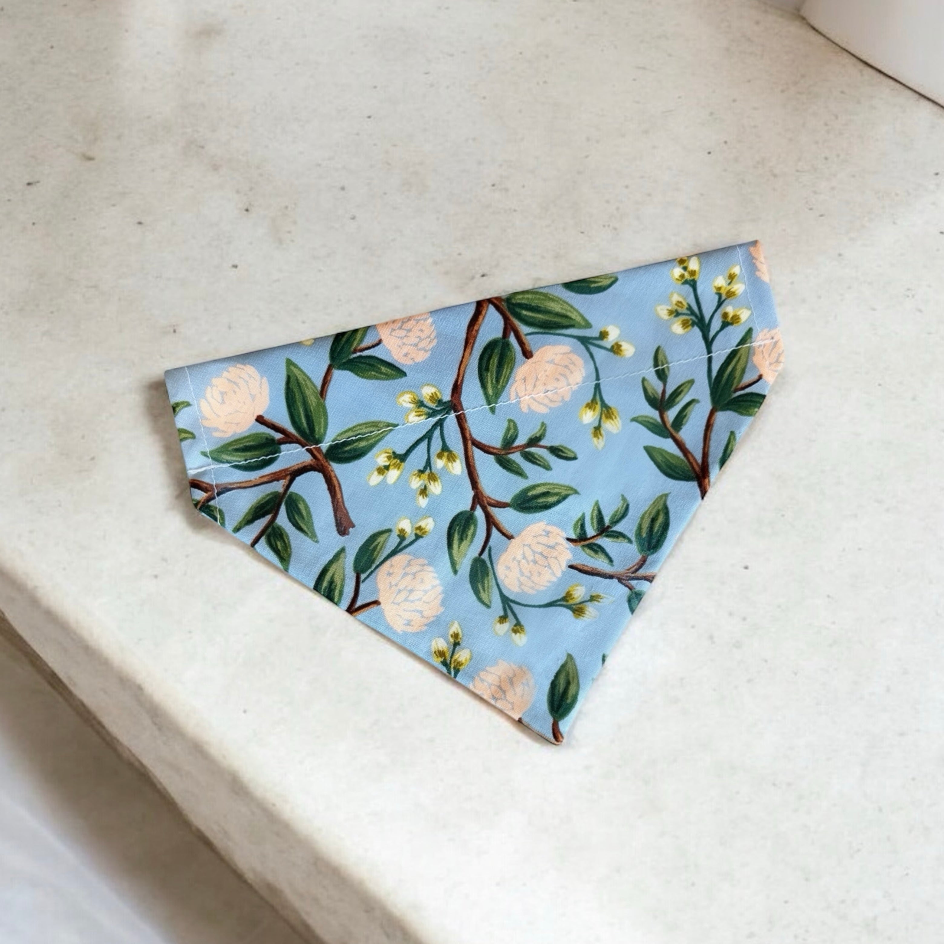 Floral Dusty Blue Dog Bandana- for summer or dog wedding outfit on a concrete table.