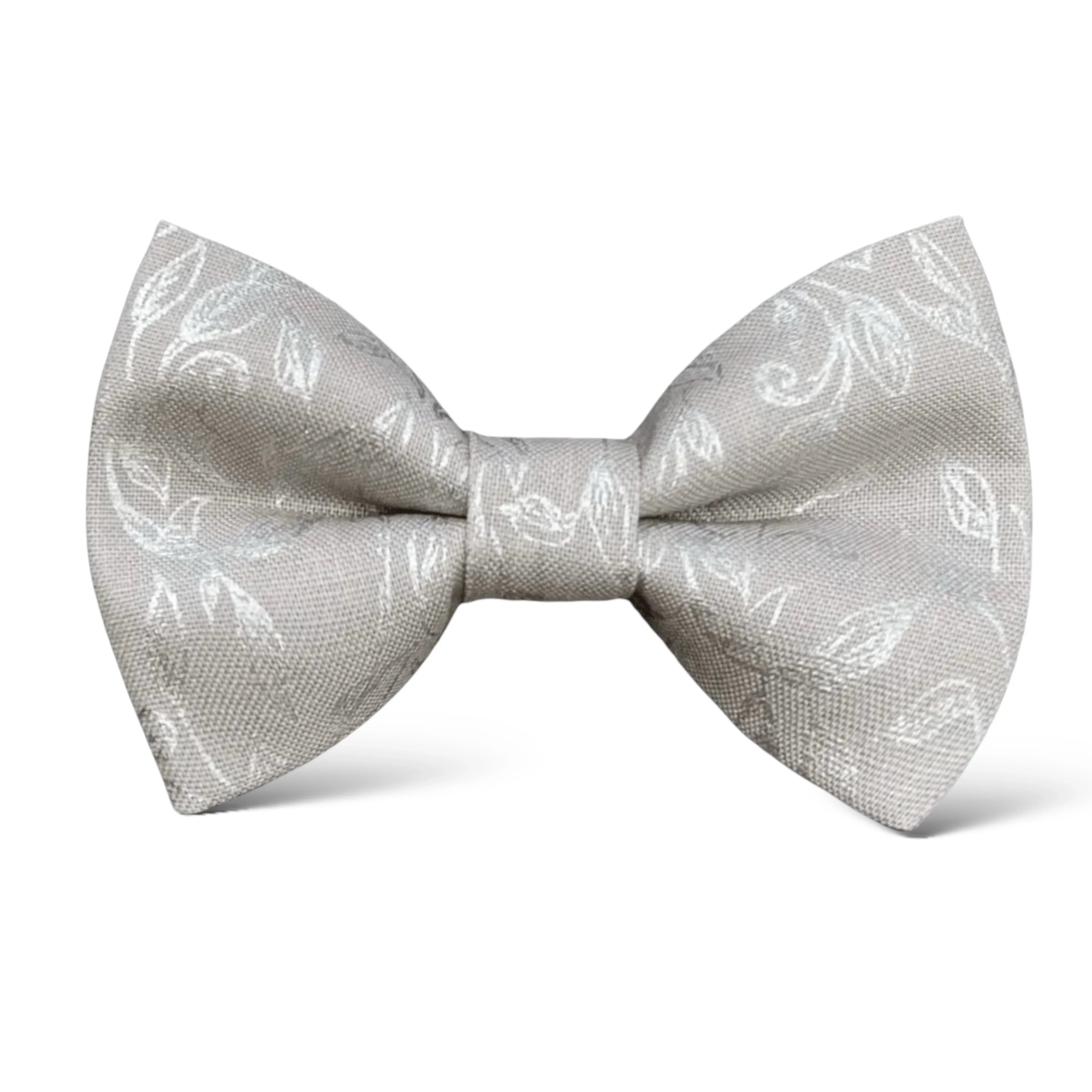 Size chart for pre-tied bow ties from The Bold Bow Tie detailing measurements across three sizes. Small is 3.5 inches wide and recommended for ages 6 months to 5 years. Medium is 4 inches wide and recommended for ages 6 to 12 years. Large is 4.5 inches wide and recommended for ages 13 years and up. Visual icons illustrate the relative sizes with horizontal arrows showing that width is measured from wingtip to wingtip. Bottom text notes that all bow ties are pre-tied and ready to add to your outfit.