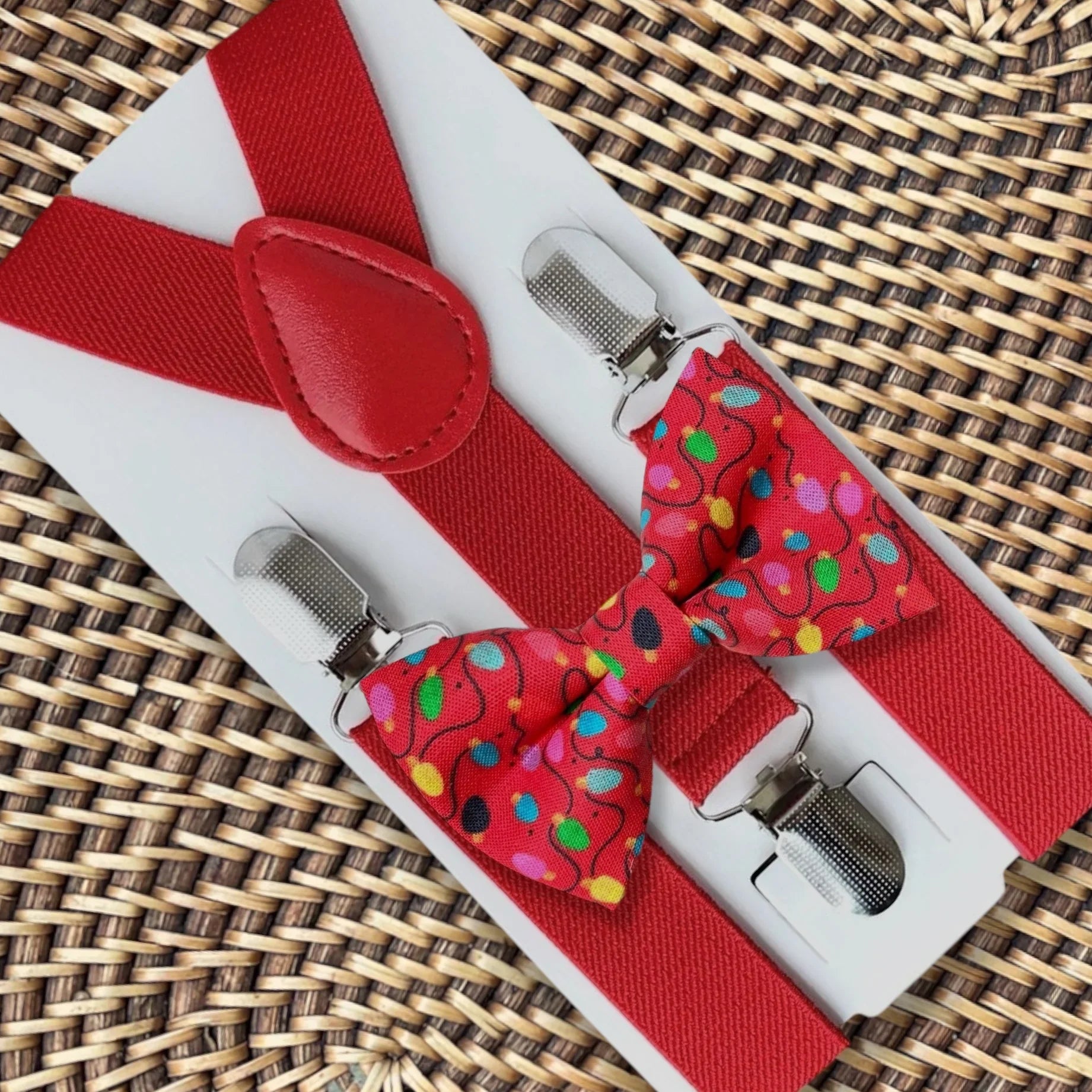 Christmas bow tie and suspenders with red lights.