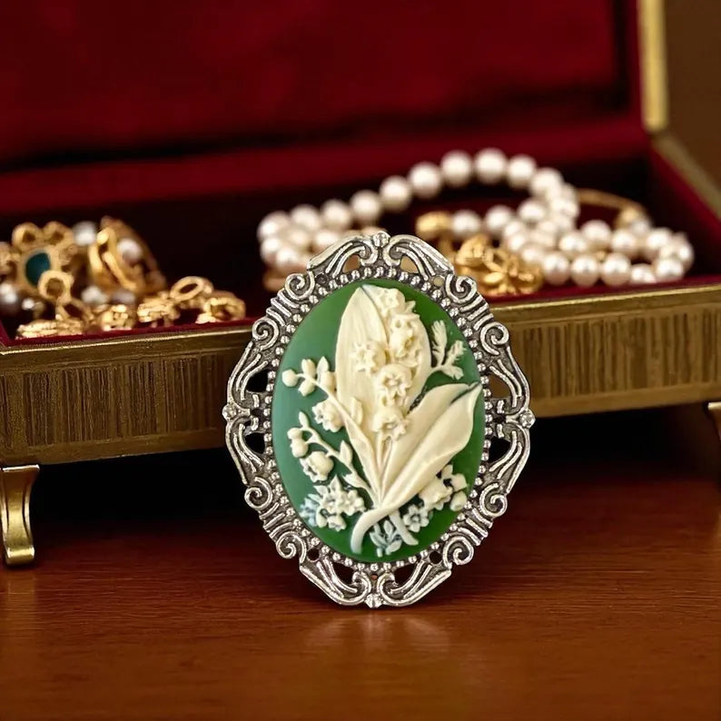 Silver Lily of the Valley Brooch, Green May Flower Brooch Pin In front of a jewelry box