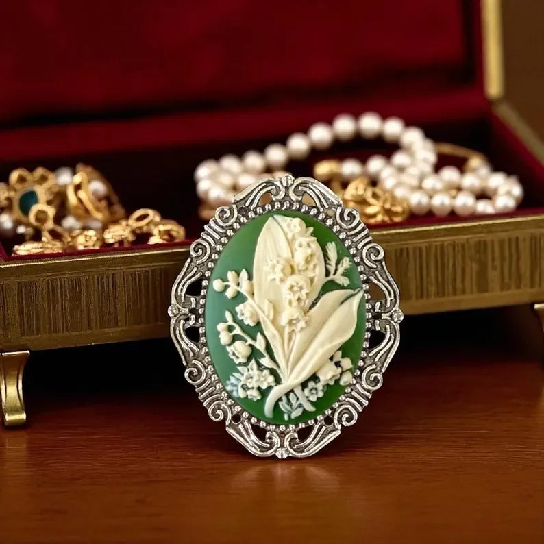 Silver Lily of the Valley Brooch, Green May Flower Brooch Pin In front of a jewelry box