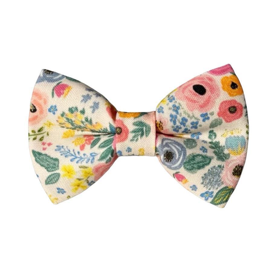 Size chart for pre-tied bow ties from The Bold Bow Tie detailing measurements across three sizes. Small is 3.5 inches wide and recommended for ages 6 months to 5 years. Medium is 4 inches wide and recommended for ages 6 to 12 years. Large is 4.5 inches wide and recommended for ages 13 years and up. Visual icons illustrate the relative sizes with horizontal arrows showing that width is measured from wingtip to wingtip. Bottom text notes that all bow ties are pre-tied and ready to add to your outfit.