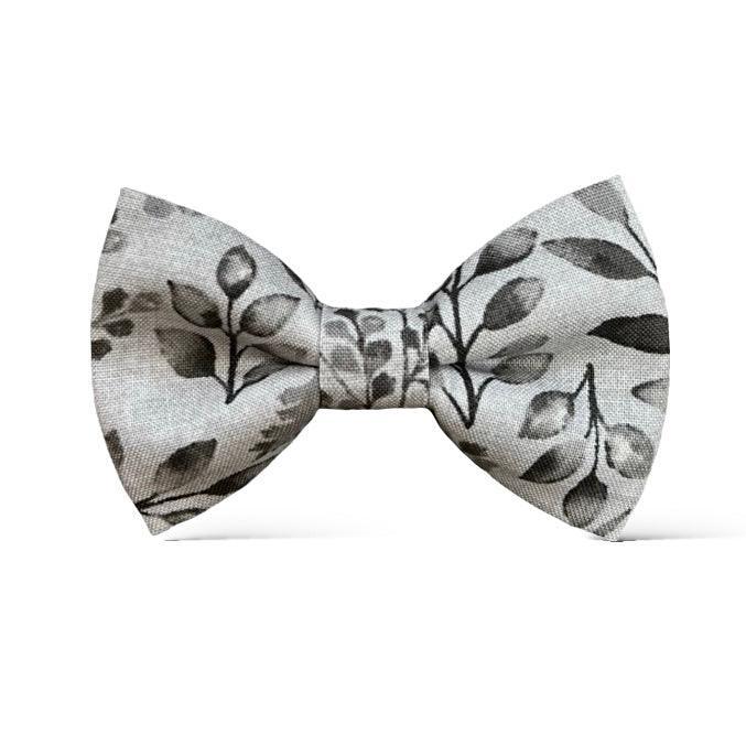 Size chart for pre-tied bow ties from The Bold Bow Tie detailing measurements across three sizes. Small is 3.5 inches wide and recommended for ages 6 months to 5 years. Medium is 4 inches wide and recommended for ages 6 to 12 years. Large is 4.5 inches wide and recommended for ages 13 years and up. Visual icons illustrate the relative sizes with horizontal arrows showing that width is measured from wingtip to wingtip. Bottom text notes that all bow ties are pre-tied and ready to add to your outfit.