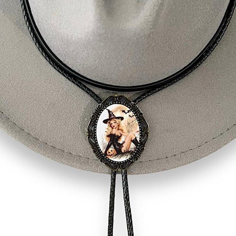 Back of a brass bolo tie with a clamp for the leather cord