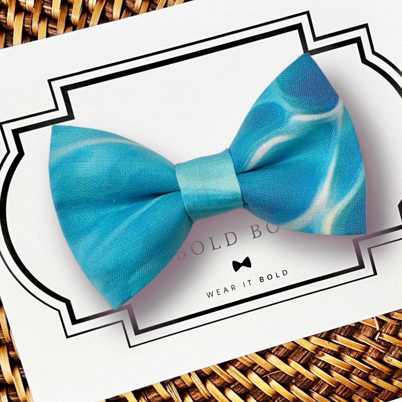 Dog bow tie size chart. Size Small is 3 1/2 inches wide for small dogs under 15 lbs. Size Medium is 4 inches wide for medium dogs between 15 band 40 lbs. Size Large is 4 1/2 inches wide for Large Dogs between 40 band 80 lbs. Size Extra Large is 5 1/2 inches wide for Extra Large Dogs over 80 lbs. Sizing is up to preference and pet bow ties slide on to dog collars with elastic.