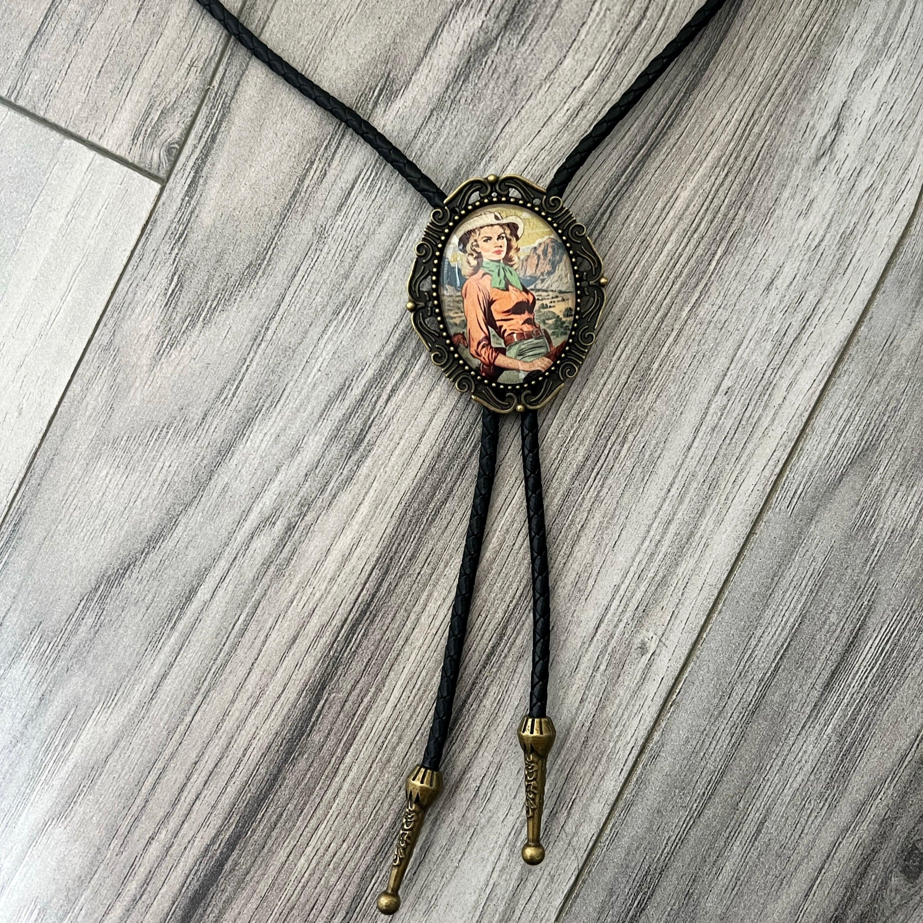 Back of a brass bolo tie with a clamp for the leather cord