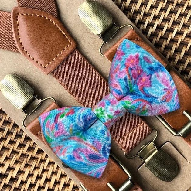 Size chart for suspender and bow tie sets from The Bold Bow Tie. X-Small (6mo-4yr): 15"-23" suspenders, 3.5" bow. Small (5-9yr): 18"-33" suspenders, 3.5" bow. Medium (10-12yr): 18"-33" suspenders, 4" bow. Adult (13yr-6'5"): 30"-53" suspenders, 4.5" bow. Big & Tall (Over 6'5"): 53"+ suspenders, 4.5" bow. Instructions note to measure from the back waistband over the shoulder to the front waistband for a comfortable fit.