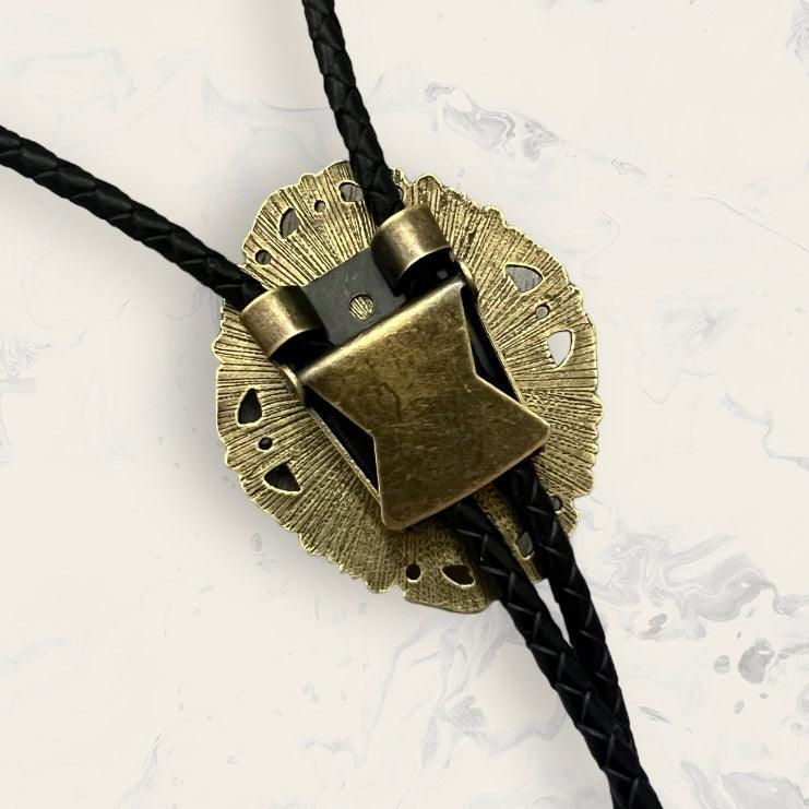 Black of a brass bolo tie clip with black leather cord