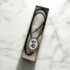 Silver Skeleton Bolo Tie for a western wedding or Cowboy gift displayed in a gift box.
