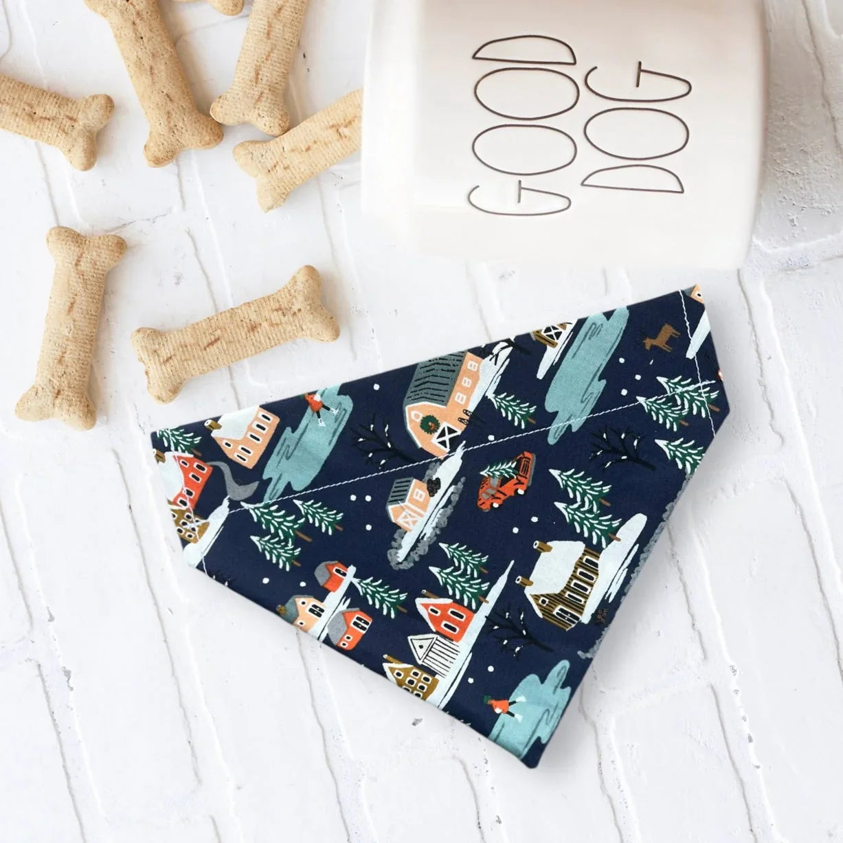 Navy blue Christmas dog bandana fabric with a winter village print.