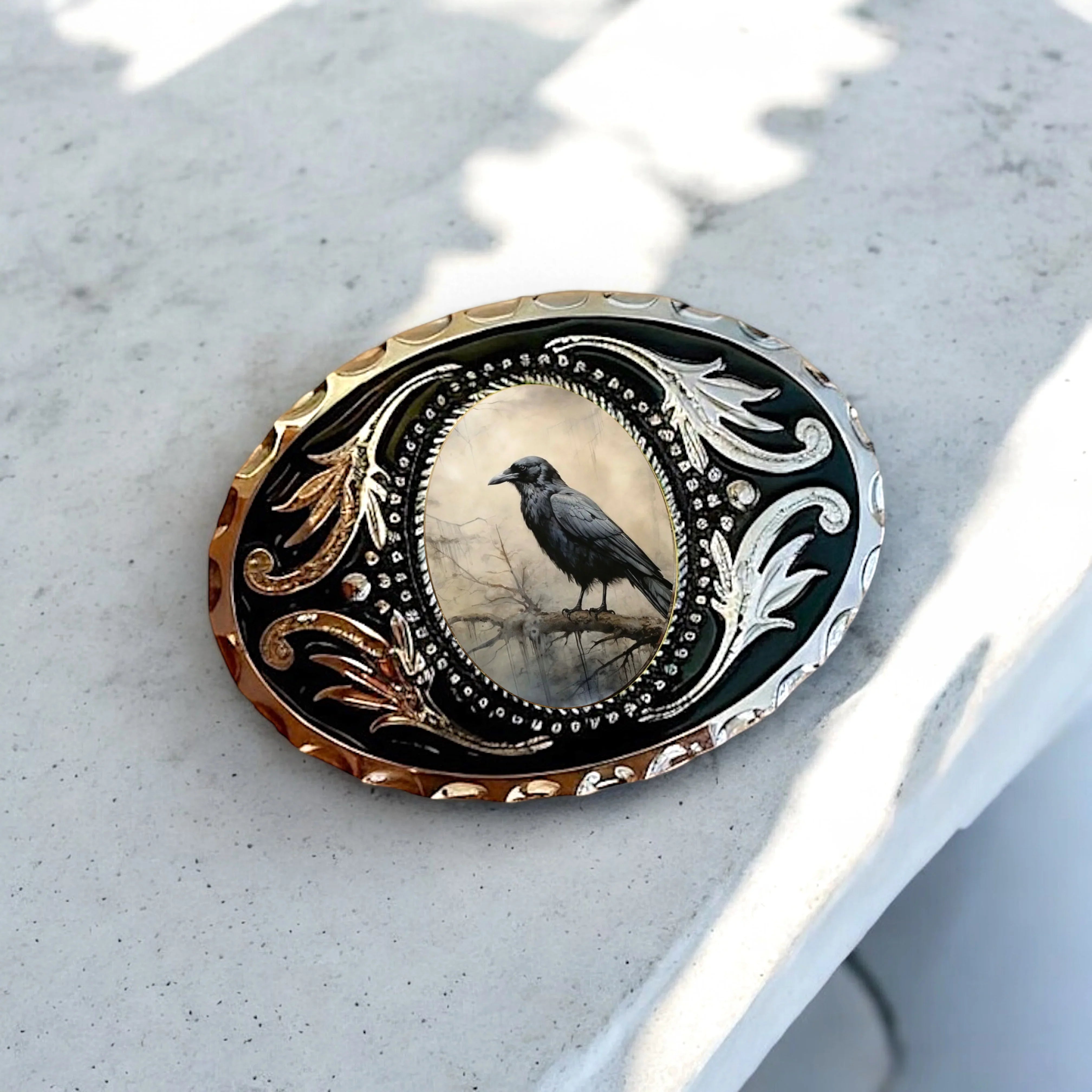 Raven perched on an ornate western belt buckle